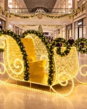 Illuminated Christmas sleigh decoration inside shopping mall