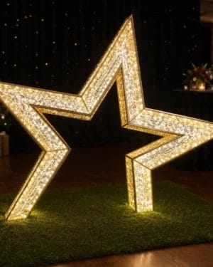 Illuminated gold star decoration at holiday event